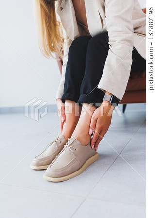 Beige women's leather shoes close-up on female legs. New collection of women's summer leather shoes. Beige women's leather shoes close-up on female legs. New collection of women's summer leather shoes. 137887196