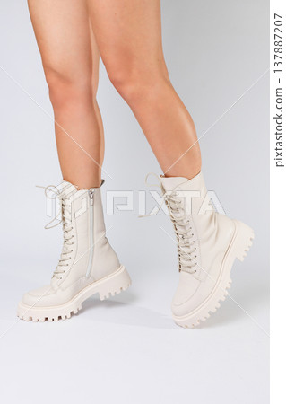 Woman's legs in a collection of fashionable leather white shoes on a white background, spring collection of women's shoes Woman's legs in a collection of fashionable leather white shoes on a white background, spring collection of women's shoes 137887207