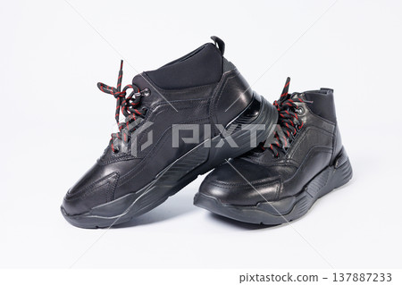 Leather black short men's autumn sneakers on a white background. Sneakers winter collection 2022. 137887233