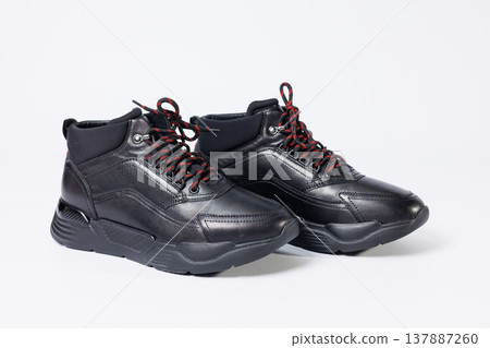 Leather black short men's autumn sneakers on a white background. Sneakers winter collection 2022. Leather black short men's autumn sneakers on a white background. Sneakers winter collection 2022. 137887260