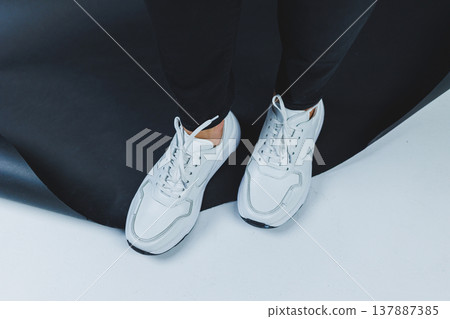 Men's casual white shoes made of genuine leather, men on shoes in white sneakers. High quality photo 137887385