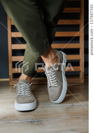 Collection of men's summer shoes. Male legs in beige leather sneakers. Men's classic shoes. Collection of men's summer shoes. Male legs in beige leather sneakers. Men's classic shoes. 137887393