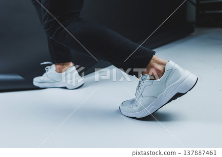 Men's casual white shoes made of genuine leather, men on shoes in white sneakers. High quality photo 137887461