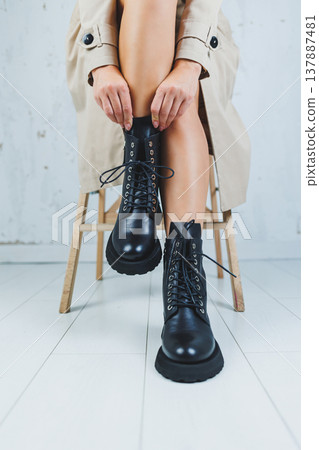 Fashionable leather lace-up boots on female feet, close-up, fashionable. New collection of leather autumn women's shoes Fashionable leather lace-up boots on female feet, close-up, fashionable. New collection of leather autumn women's shoes 137887481