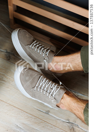 Collection of men's summer shoes. Male legs in beige leather sneakers. Men's classic shoes. Collection of men's summer shoes. Male legs in beige leather sneakers. Men's classic shoes. 137887536