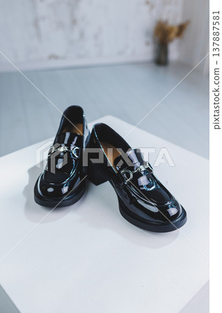 Women's leather shoes with a massive heel. Black autumn shoes for women on a white background. Women's leather shoes with a massive heel. Black autumn shoes for women on a white background. 137887581