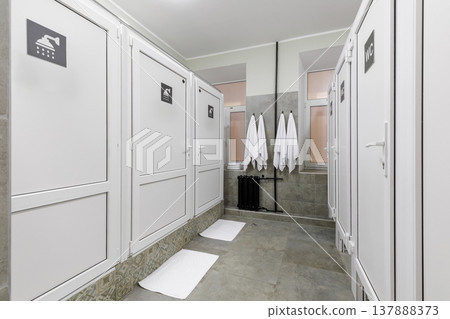 Modern Shared Hostel Bathroom with White Shower and Toilet Stalls Modern Shared Hostel Bathroom with White Shower and Toilet Stalls 137888373