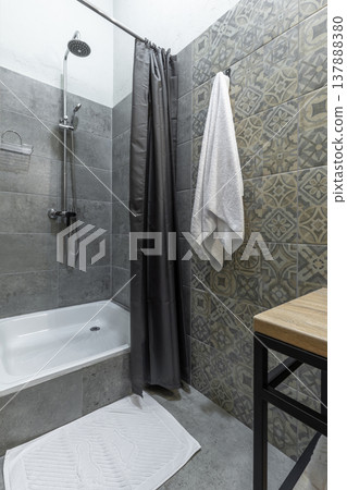 Modern Hostel Bathroom with Shower Stall and Patterned Wall Tiles 137888380