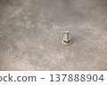 screw fastening nut on cement floor in construction working 137888904