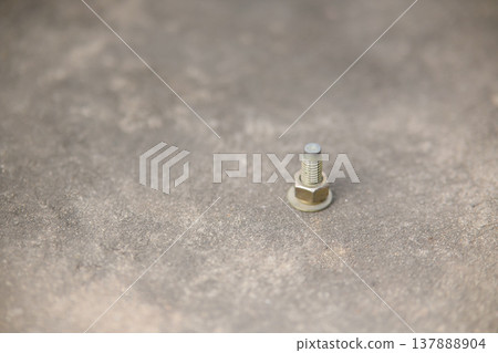 screw fastening nut on cement floor in construction working screw fastening nut on cement floor in construction working 137888904