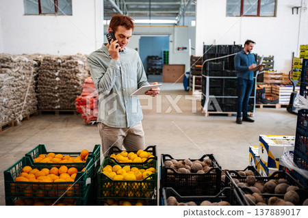 Warehouse workers managing inventory and fresh produce using technology Warehouse workers managing inventory and fresh produce using technology 137889017