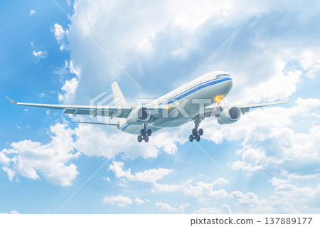 A plane flying through the sky against a background of clouds. Flights and air travel, sale of Ruhr and airline tickets, and tourism. High quality photo A plane flying through the sky against a background of clouds. Flights and air travel, sale of Ruhr and airline tickets, and tourism. High quality photo 137889177