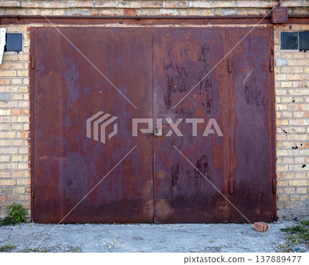 old metal door to the car garage old metal door to the car garage 137889477