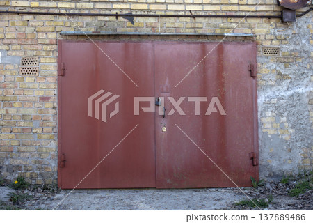 old metal door to the car garage old metal door to the car garage 137889486
