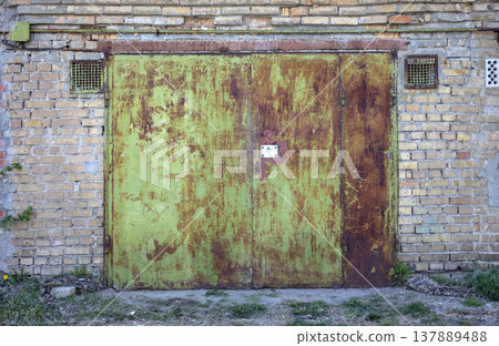 old metal door to the car garage old metal door to the car garage 137889488