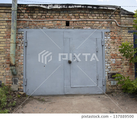 old metal door to the car garage 137889500