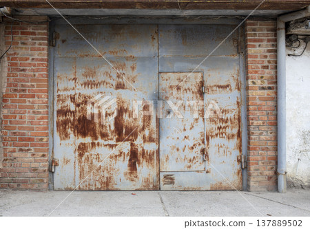 old metal door to the car garage old metal door to the car garage 137889502