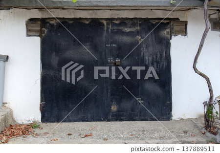 old metal door to the car garage 137889511