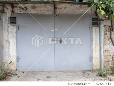 old metal door to the car garage old metal door to the car garage 137889514