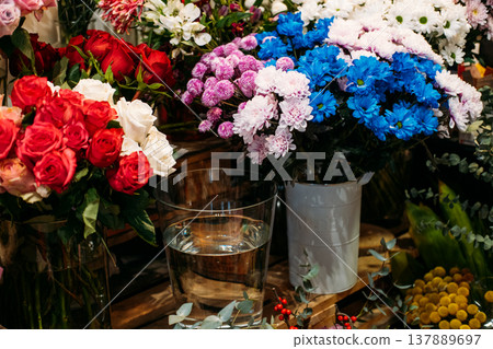Assorted bouquets featuring roses and chrysanthemums stand in vases on wooden display. Mothers Day gifts, sustainable flowers, eco-friendly packaging. Assorted bouquets featuring roses and chrysanthemums stand in vases on wooden display. Mothers Day gifts, sustainable flowers, eco-friendly packaging. 137889697
