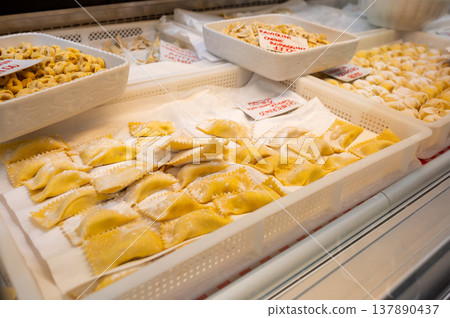 Genoa, liguria, italy. May 18, 2024. Freshly made italian pasta, including ravioli and tortellini, displayed for sale at a market stall in genoa, italy Genoa, liguria, italy. May 18, 2024. Freshly made italian pasta, including ravioli and tortellini, displayed for sale at a market stall in genoa, italy 137890437