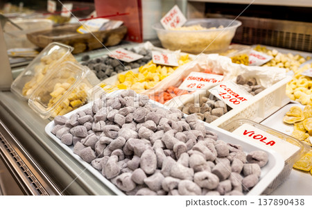 Genoa, liguria, italy. May 18, 2024. Eastern market in genoa displaying a variety of fresh artisanal gnocchi and pasta, including purple, yellow, and red options Genoa, liguria, italy. May 18, 2024. Eastern market in genoa displaying a variety of fresh artisanal gnocchi and pasta, including purple, yellow, and red options 137890438