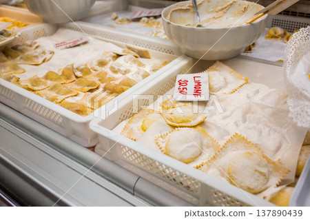 Genoa, liguria, italy. May 18, 2024. Freshly made ravioli with lemon filling and traditional pasta are displayed in trays at mercato orientale in genoa, italy 137890439