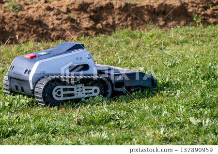 Automatic, cordless electric robotic lawnmower with GPS, saving you time taking care of the garden Automatic, cordless electric robotic lawnmower with GPS, saving you time taking care of the garden 137890959