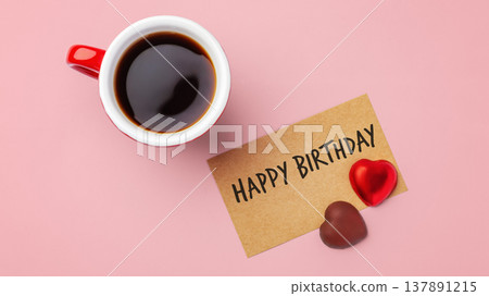 Happy birthday paper card with heart chocolate and coffee cup on pink background 137891215