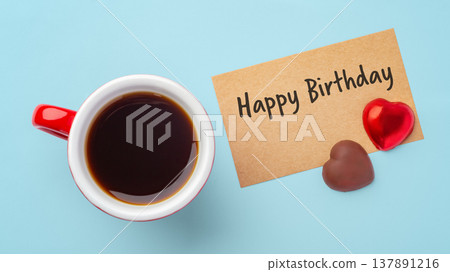 Happy birthday paper card with heart chocolate and coffee cup on blue background 137891216