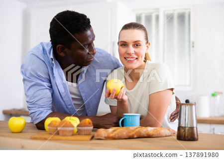 Loving couple enjoying while spending time together in home kitchen 137891980