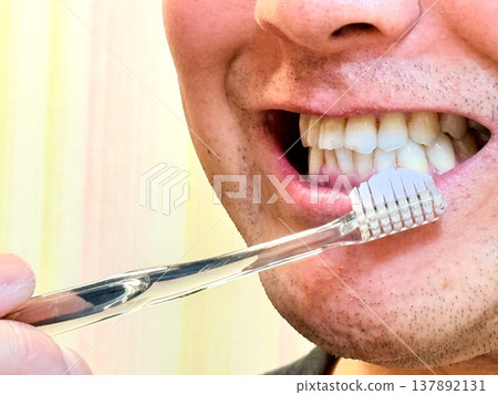 A man brushing his front teeth. A man brushing his front teeth. 137892131