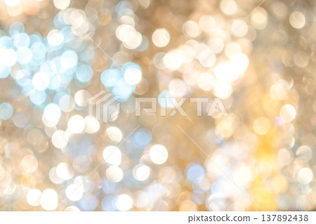 Golden bokeh lights with blurred circular highlights and warm tone creating an abstract light pattern suitable for luxury background use. Golden bokeh lights with blurred circular highlights and warm tone creating an abstract light pattern suitable for luxury background use. 137892438