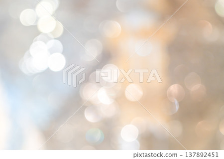 Cool toned bokeh lights with soft blur and scattered highlights forming an abstract lighting pattern that creates a calm winter mood for seasonal design use. 137892451