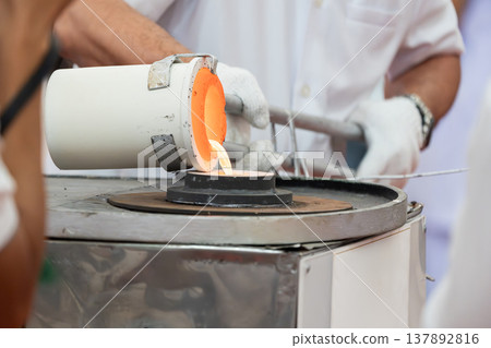 Industrial furnace with glowing opening showing high temperature inside. Metal equipment used for heating and material processing in Thai Temple Event. Industrial furnace with glowing opening showing high temperature inside. Metal equipment used for heating and material processing in Thai Temple Event. 137892816