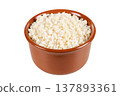 Dried, raw white corn used to prepare canjica, Brazilian corn dessert, in a brown ceramic bowl, isolated against a white background 137893361