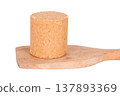 One pacocas, a traditional Brazilian sweet made with peanuts, on an isolated wooden base against a white background 137893369
