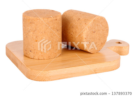 Two pacocas, a traditional Brazilian sweet made with peanuts, on an isolated wooden base against a white background Two pacocas, a traditional Brazilian sweet made with peanuts, on an isolated wooden base against a white background 137893370