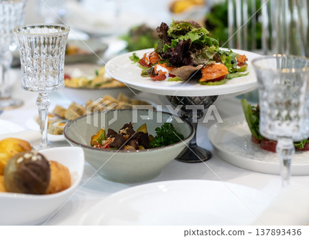 Elegant Restaurant Table Setting with Glasses and Plates. Elegant Restaurant Table Setting with Glasses and Plates. 137893436