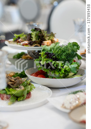 Elegant Restaurant Table Setting with Glasses and Plates. Salad Elegant Restaurant Table Setting with Glasses and Plates. Salad 137893438