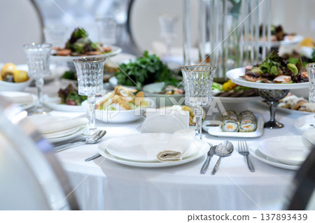 Elegant Restaurant Table Setting with Glasses and Plates. Elegant Restaurant Table Setting with Glasses and Plates. 137893439