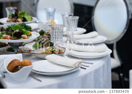 Elegant Restaurant Table Setting with Glasses and Plates. Elegant Restaurant Table Setting with Glasses and Plates. 137893470