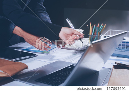 Professional photo of a person's hands reviewing a contract or legal document on a desk, for concepts of business, finance, and legal affairs Professional photo of a person's hands reviewing a contract or legal document on a desk, for concepts of business, finance, and legal affairs 137893691