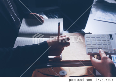 Professional photo of a person's hands reviewing a contract or legal document on a desk, for concepts of business, finance, and legal affairs Professional photo of a person's hands reviewing a contract or legal document on a desk, for concepts of business, finance, and legal affairs 137893703
