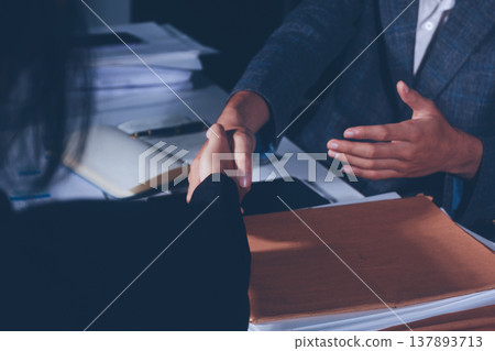 Professional photo of a person's hands reviewing a contract or legal document on a desk, for concepts of business, finance, and legal affairs Professional photo of a person's hands reviewing a contract or legal document on a desk, for concepts of business, finance, and legal affairs 137893713