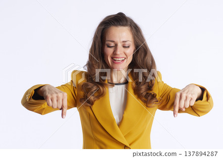 Blissful Businesswoman Pointing Down with Eyes Closed 137894287