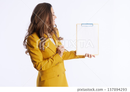 Focused Businesswoman Reviewing Clipboard Focused Businesswoman Reviewing Clipboard 137894293