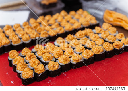 Rows Of Baked Gunkan Sushi Lined On Red Prep Table In Sushi Restaurant Kitchen Creamy Spicy Rows Of Baked Gunkan Sushi Lined On Red Prep Table In Sushi Restaurant Kitchen Creamy Spicy 137894585