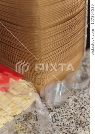 Stacked Cardboard Boxes Beside Sushi Prep Area, Wrapped Plastic And Packaging Materials On Speckled Stacked Cardboard Boxes Beside Sushi Prep Area, Wrapped Plastic And Packaging Materials On Speckled 137894589