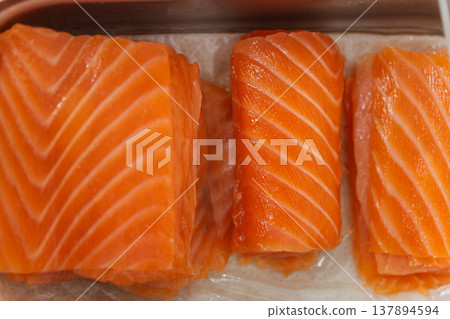 Vacuum Sealed Salmon Slices Showing Marbling And Glossy Surface, Packaging Seal Visible, 137894594